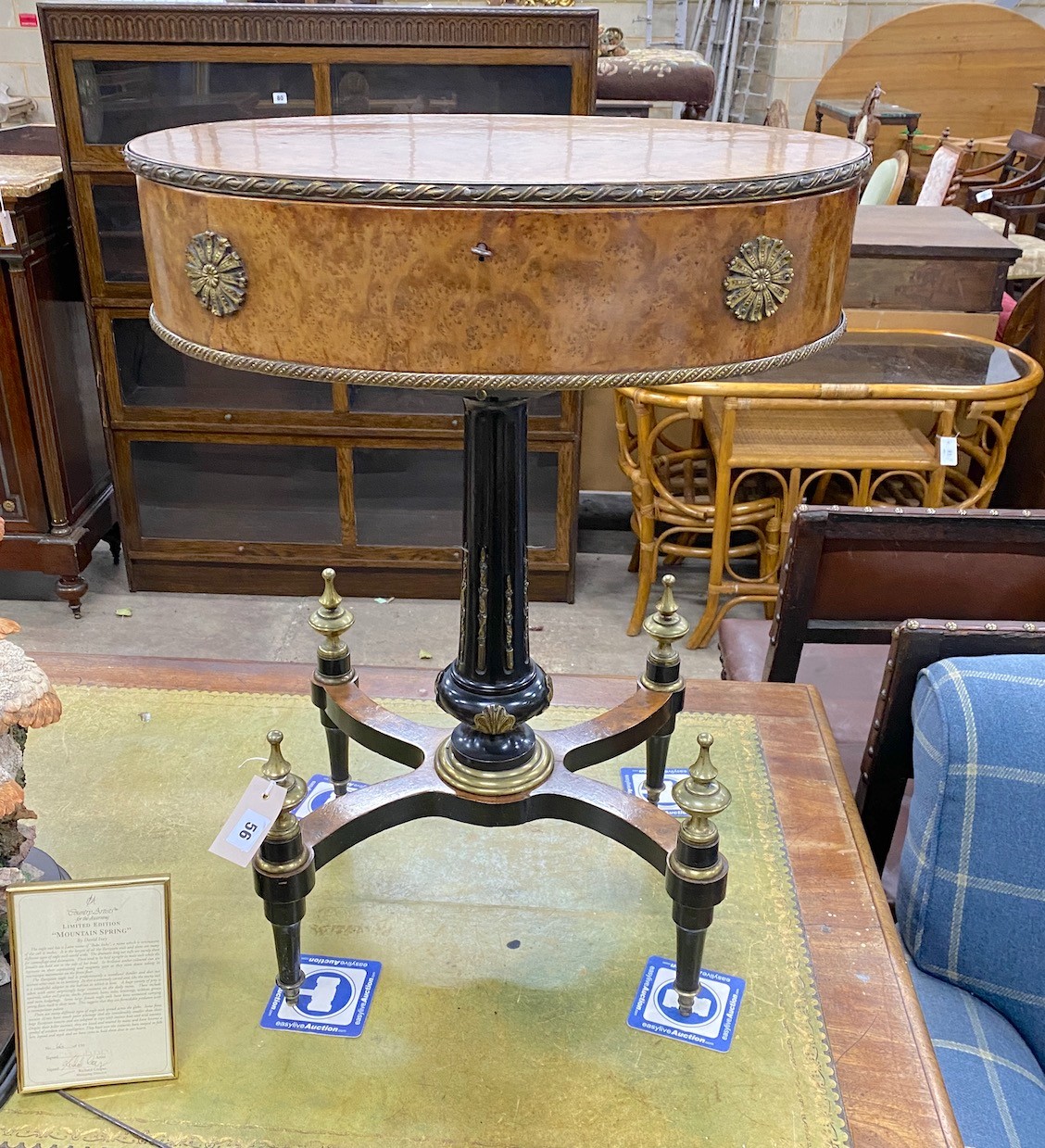 An early 20th century French gilt metal mounted part ebonised bird's eye maple oval work table, width 55cm, depth 39cm, height 74cm